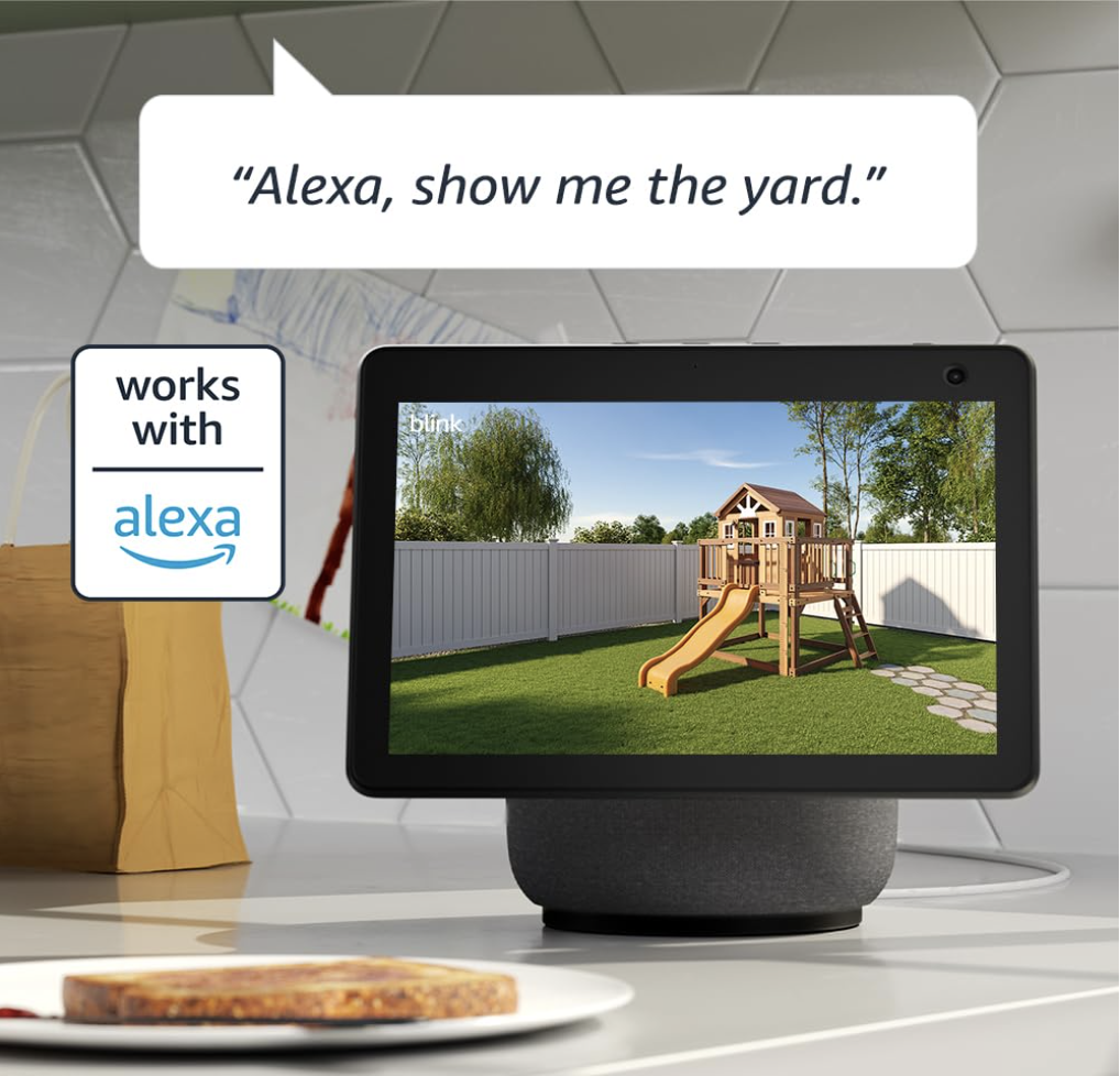 Blink Outdoor 4 live feed displayed on Alexa smart display showing a backyard playground, with voice command “Alexa, show me the yard”