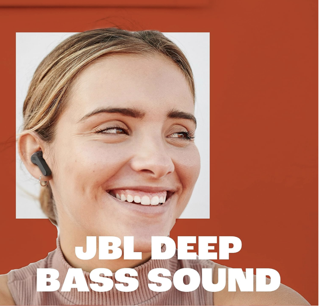 Woman smiling while wearing JBL Vibe Beam earbuds, highlighting JBL Deep Bass Sound