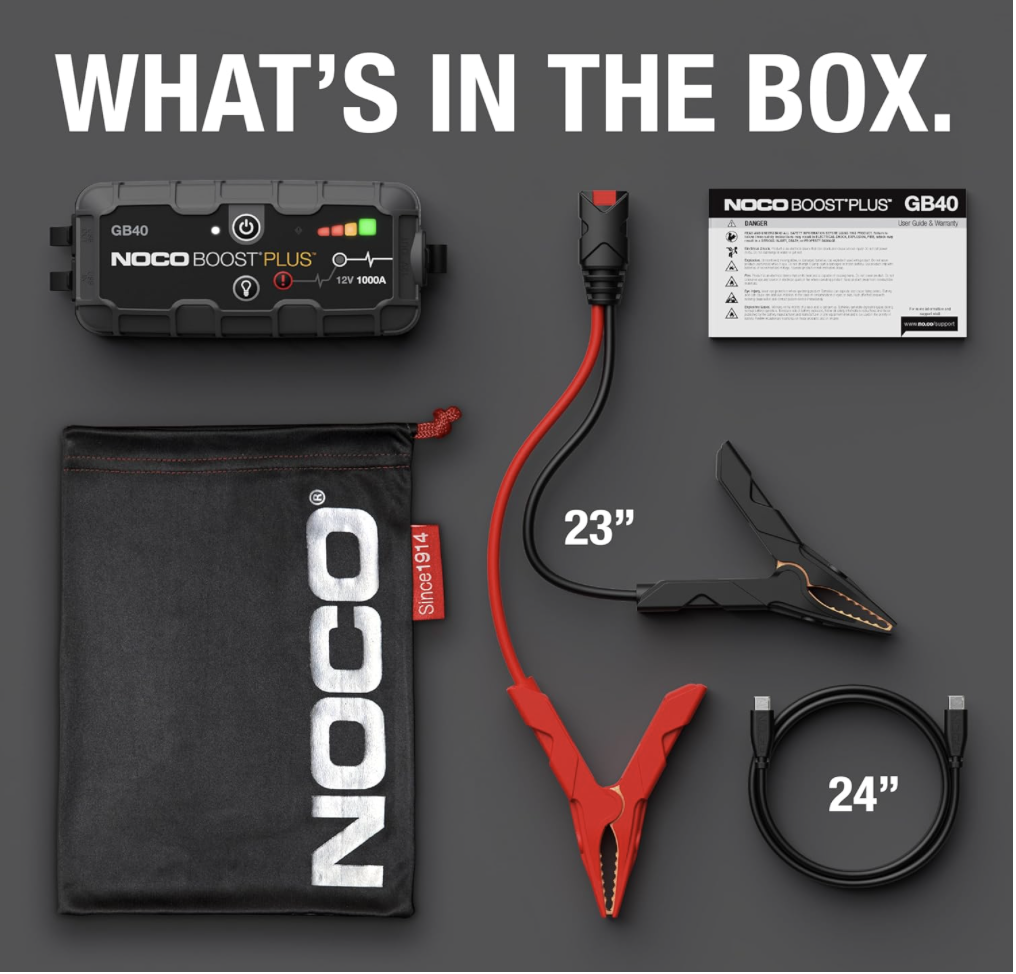 NOCO GB40 Boost Plus jump starter with included clamps, USB cable, user manual, and branded storage bag laid out in box contents view
