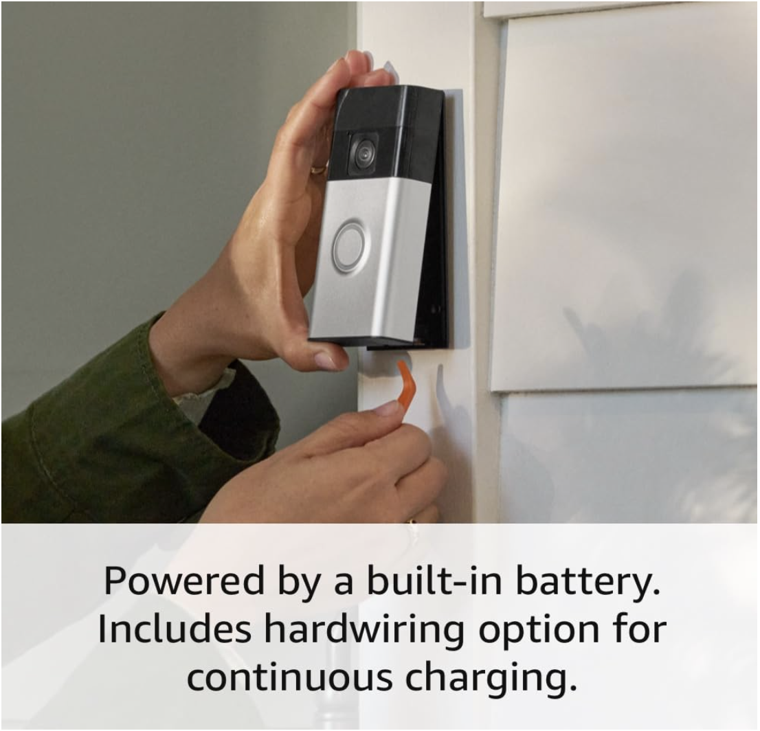 A person removes the Ring Battery Doorbell from a wall mount using the included tool, showing its built-in battery and optional hardwiring setup.
