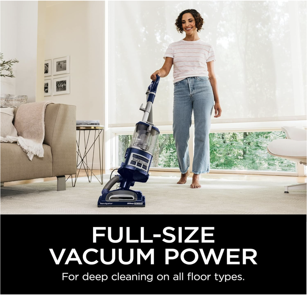 Woman using the Shark NV360 vacuum on carpet, demonstrating full-size vacuum power for deep cleaning on all floor types.