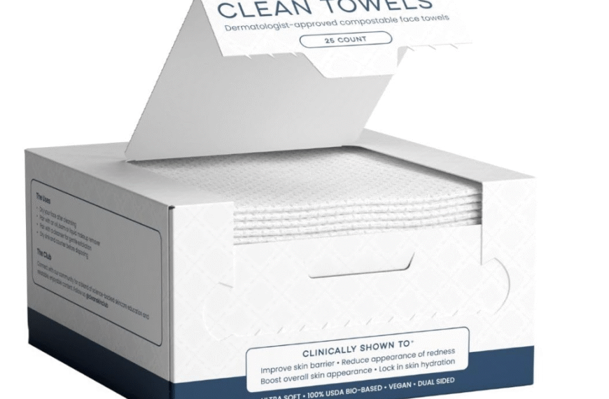 Open box of Clean Skin Club Clean Towels™ showing stack of dermatologist-approved, 100% biobased disposable face towels (25 count) for hygienic skincare use.