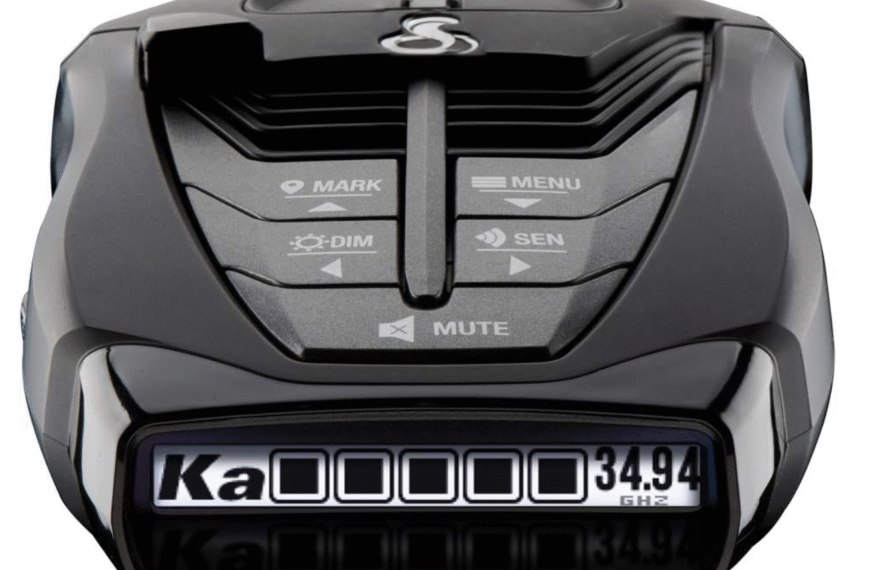 Close-up of Cobra RAD 480i radar detector controls including menu, sensitivity, mute, and OLED Ka-band display.