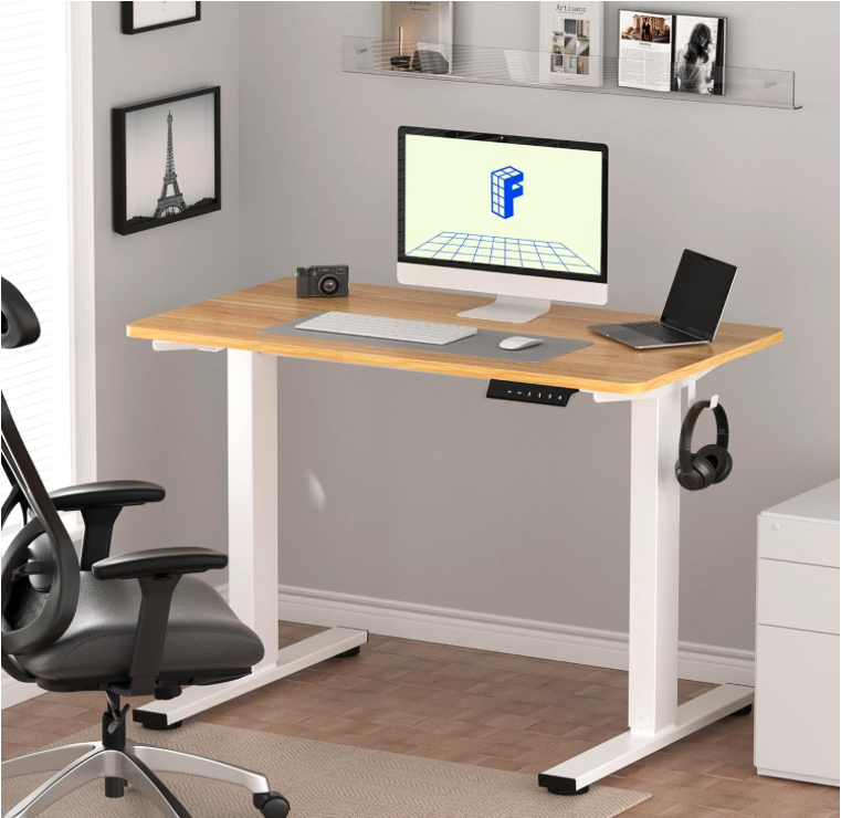 FLEXISPOT EN1 standing desk in a modern home office with white frame, maple top, and dual screen setup