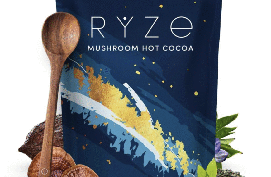 Ryze Mushroom Hot Cocoa bag with wooden spoon and mushroom ingredients displayed.